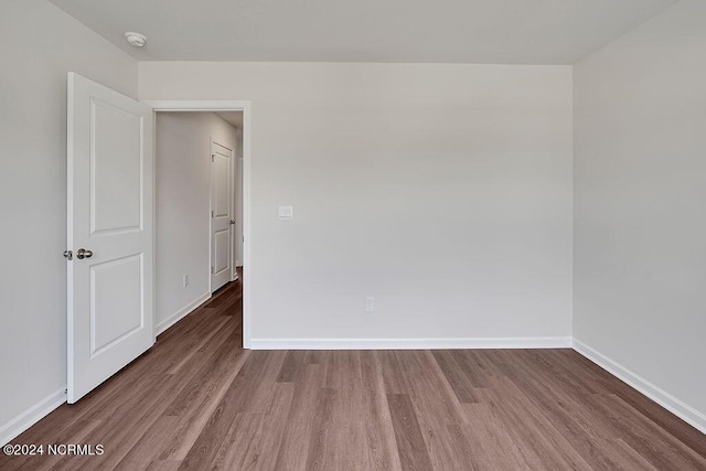 246 Kite Cir NE Lot 667, Bolivia, NC 28422 - empty room with wood finished floors, baseboards, and a smoke detector