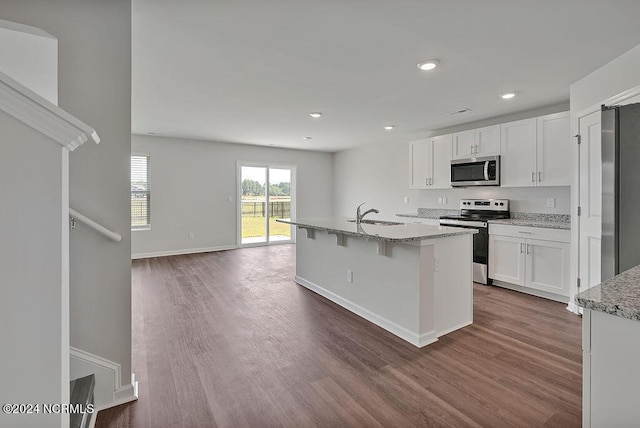 246 Kite Cir NE Lot 667, Bolivia, NC 28422 - kitchen featuring stainless steel appliances, dark wood-style flooring, white cabinets, baseboards, and light stone counters