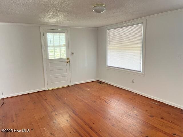 3356 Howard Ave, Tarboro, NC 27886 - empty room featuring hardwood / wood-style flooring, baseboards, a textured ceiling, and ornamental molding