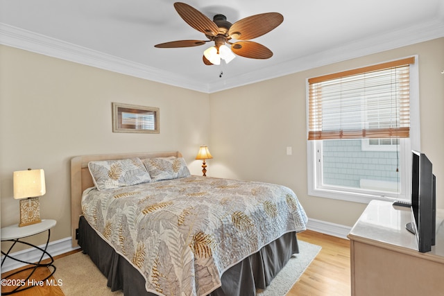 612 N Carolina Beach Ave Unit 3A, Carolina Beach, NC 28428 - bedroom featuring ornamental molding, light wood-style flooring, baseboards, and a ceiling fan