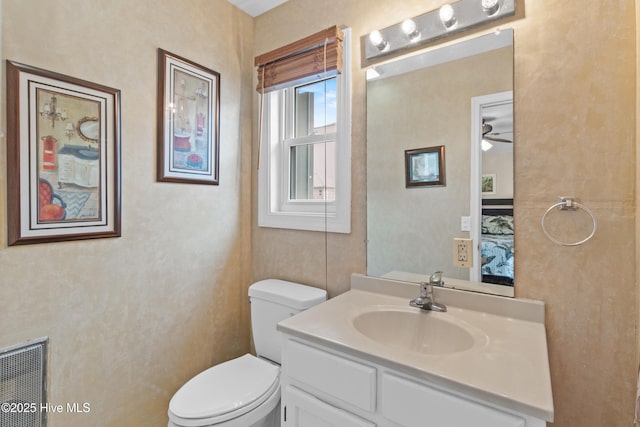 612 N Carolina Beach Ave Unit 3A, Carolina Beach, NC 28428 - ensuite bathroom featuring vanity, toilet, and a ceiling fan