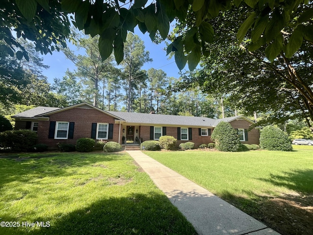 1215 Dunbar Dr, Laurinburg, NC 28352 - ranch-style house featuring brick siding and a front lawn