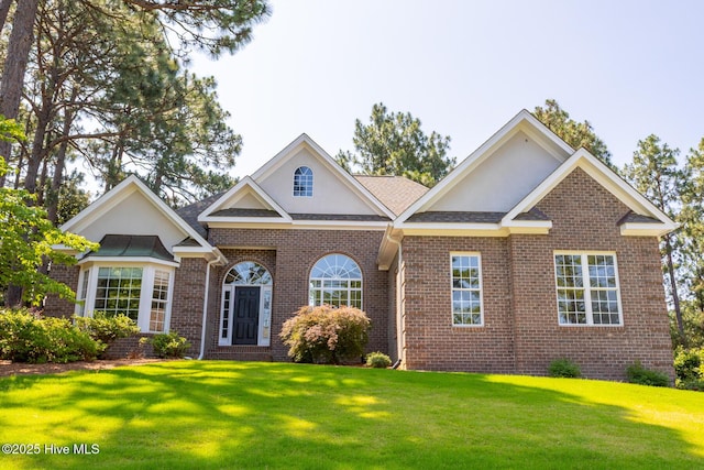 24 Mcnish Rd, Southern Pines, NC 28387 - view of front facade with a front lawn, brick siding, and stucco siding