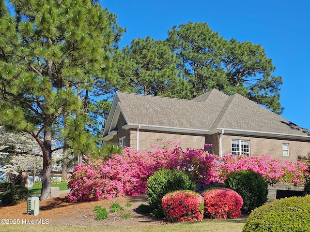 24 Mcnish Rd, Southern Pines, NC 28387 - view of property exterior with a shingled roof and brick siding