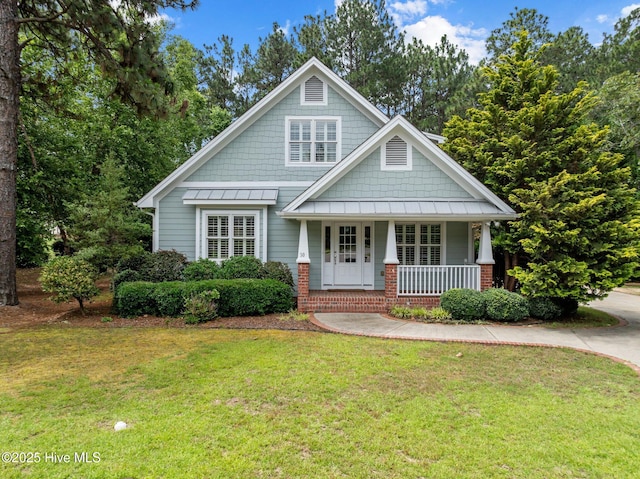 30 Deacon Palmer Pl, Southern Pines, NC 28387 - craftsman-style home with a porch, a front yard, a standing seam roof, a metal roof, and brick siding