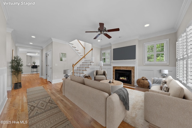 30 Deacon Palmer Pl, Southern Pines, NC 28387 - living area with light wood-type flooring, a ceiling fan, a lit fireplace, recessed lighting, and stairway
