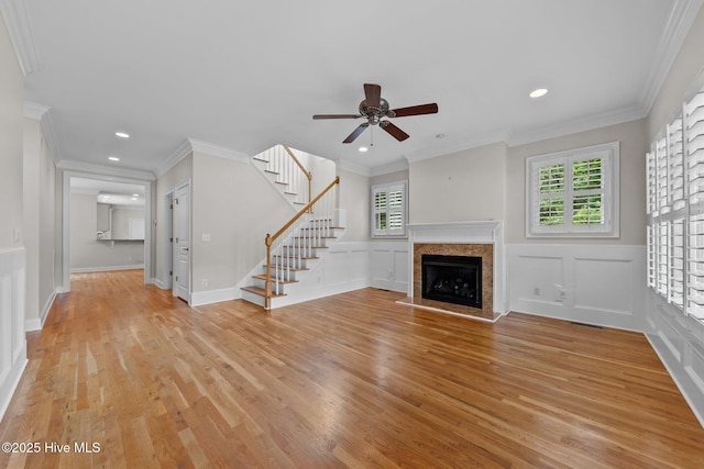 30 Deacon Palmer Pl, Southern Pines, NC 28387 - unfurnished living room with light wood-style flooring, a ceiling fan, stairs, a fireplace with raised hearth, and recessed lighting