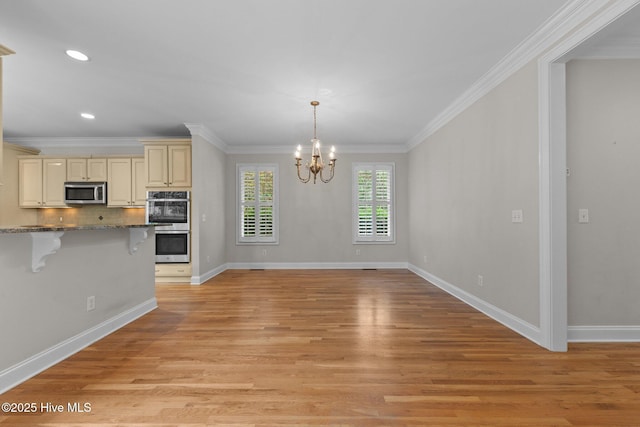 30 Deacon Palmer Pl, Southern Pines, NC 28387 - kitchen featuring cream cabinets, a kitchen breakfast bar, stainless steel appliances, a chandelier, and light wood finished floors