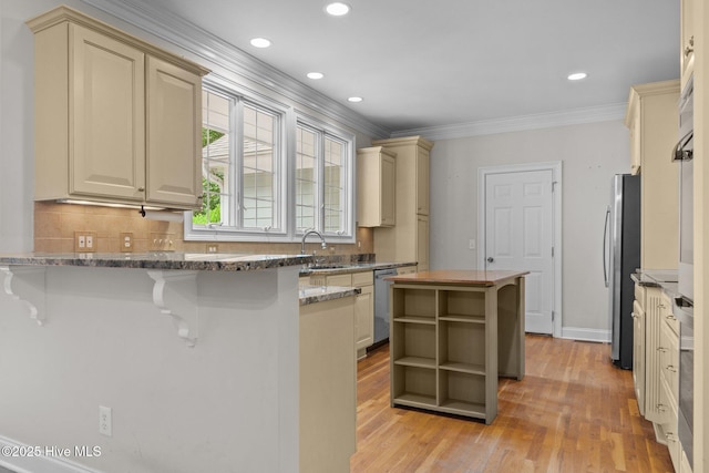 30 Deacon Palmer Pl, Southern Pines, NC 28387 - kitchen featuring crown molding, stainless steel appliances, a peninsula, light wood-style floors, and backsplash