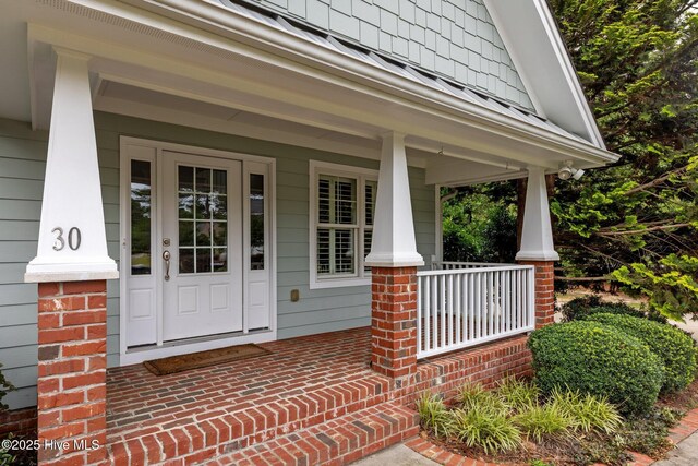 30 Deacon Palmer Pl, Southern Pines, NC 28387 - view of exterior entry featuring covered porch and brick siding