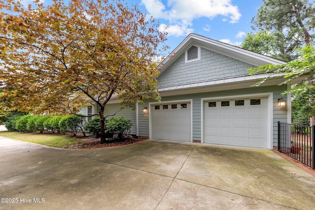 30 Deacon Palmer Pl, Southern Pines, NC 28387 - view of home's exterior with driveway, a garage, and a standing seam roof