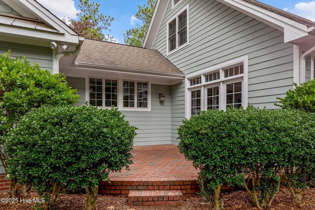 30 Deacon Palmer Pl, Southern Pines, NC 28387 - view of exterior entry with a shingled roof and a patio area