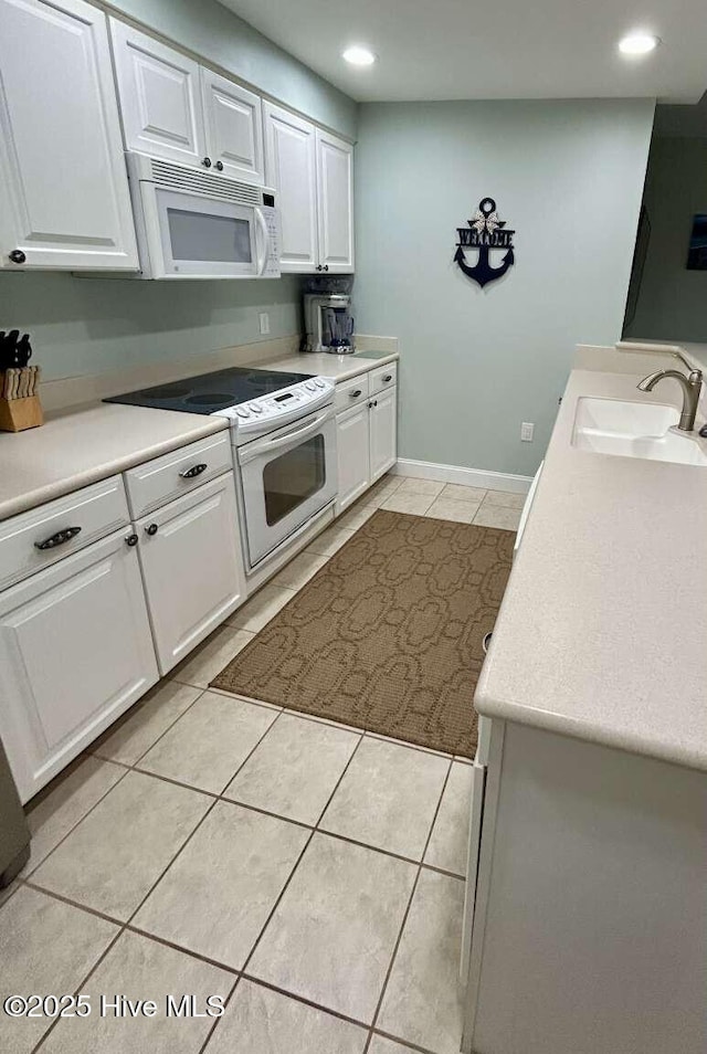 104 S 3rd St Unit H2, Morehead City, NC 28557 - kitchen with white appliances, a sink, light tile patterned flooring, white cabinetry, and recessed lighting