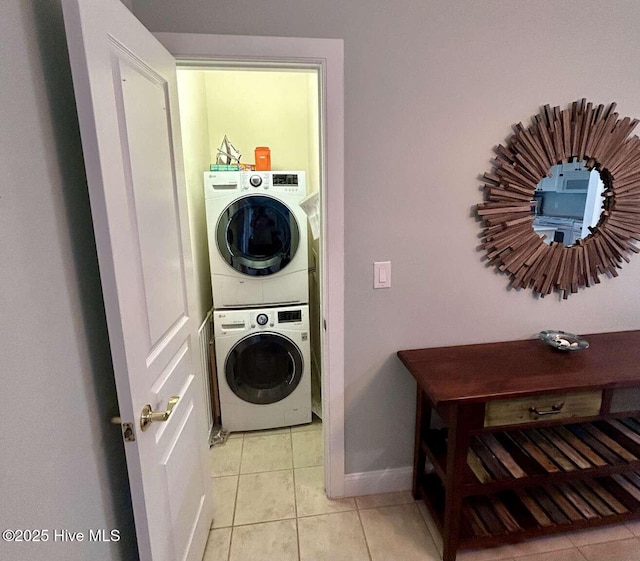 104 S 3rd St Unit H2, Morehead City, NC 28557 - washroom with stacked washer and clothes dryer, light tile patterned floors, and baseboards
