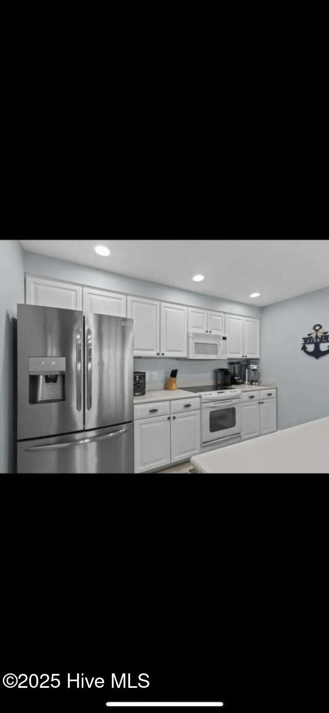 104 S 3rd St Unit H2, Morehead City, NC 28557 - kitchen featuring white appliances, white cabinetry, and light countertops