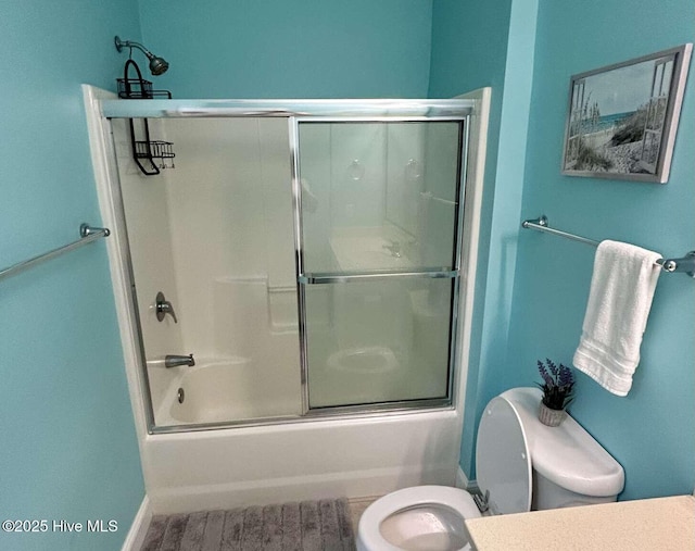104 S 3rd St Unit H2, Morehead City, NC 28557 - bathroom featuring toilet, bath / shower combo with glass door, wood finished floors, vanity, and baseboards