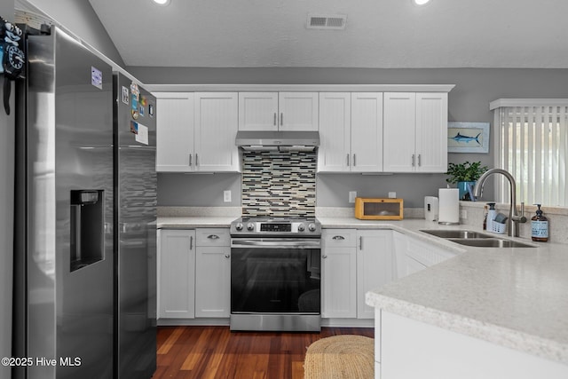 8122 Bahia Honda Dr, Wilmington, NC 28412 - kitchen featuring appliances with stainless steel finishes, a sink, dark wood-style flooring, white cabinetry, and under cabinet range hood