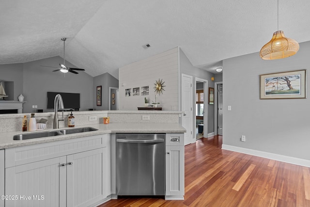 8122 Bahia Honda Dr, Wilmington, NC 28412 - kitchen featuring dishwasher, a sink, ceiling fan, lofted ceiling, and white cabinetry