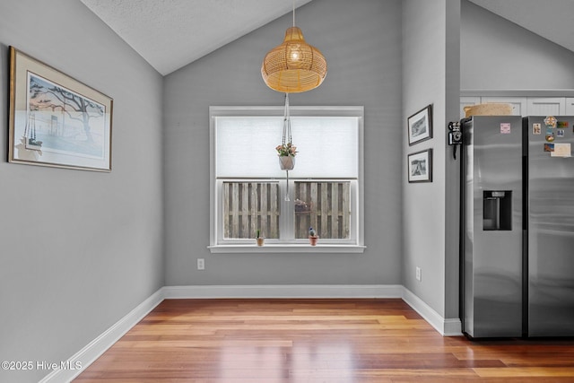 8122 Bahia Honda Dr, Wilmington, NC 28412 - unfurnished dining area with vaulted ceiling, wood finished floors, and baseboards