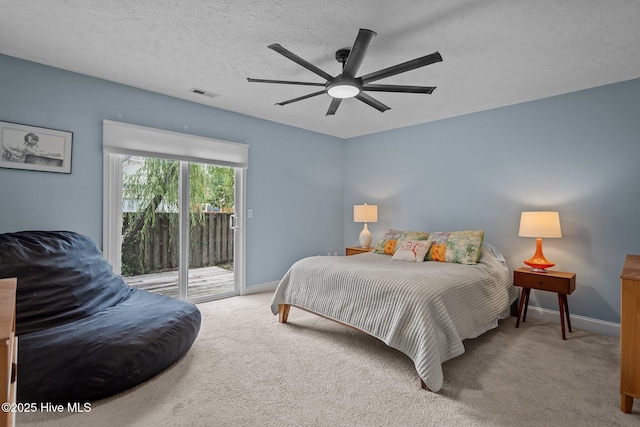 8122 Bahia Honda Dr, Wilmington, NC 28412 - carpeted bedroom with access to outside, baseboards, a ceiling fan, and a textured ceiling