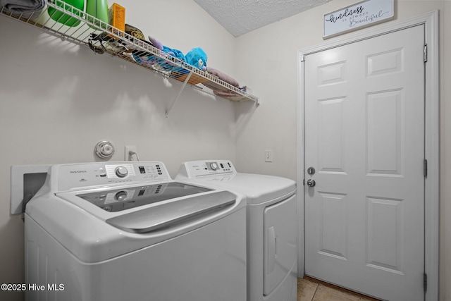 8122 Bahia Honda Dr, Wilmington, NC 28412 - laundry room with washing machine and dryer, a textured ceiling, and light tile patterned floors
