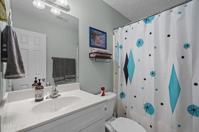 8122 Bahia Honda Dr, Wilmington, NC 28412 - bathroom with a textured ceiling, vanity, toilet, and a shower with shower curtain
