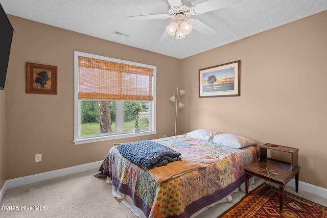 8122 Bahia Honda Dr, Wilmington, NC 28412 - carpeted bedroom with baseboards, ceiling fan, and a textured ceiling