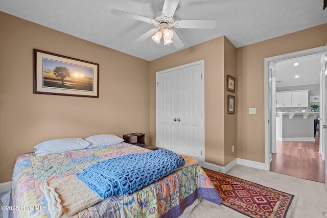 8122 Bahia Honda Dr, Wilmington, NC 28412 - bedroom featuring a closet, carpet, baseboards, a ceiling fan, and a textured ceiling