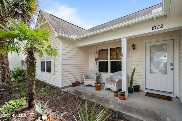 8122 Bahia Honda Dr, Wilmington, NC 28412 - doorway to property with a shingled roof and covered porch