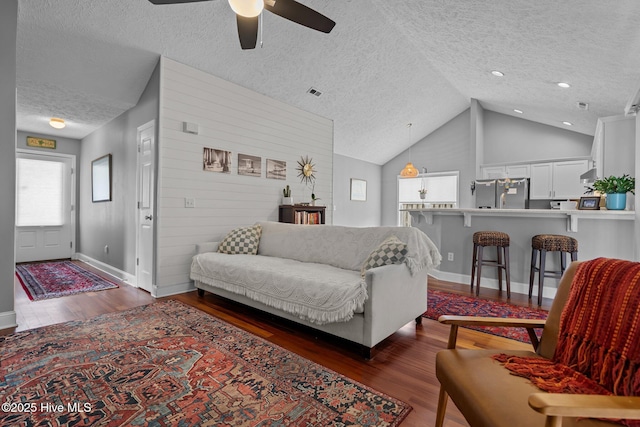 8122 Bahia Honda Dr, Wilmington, NC 28412 - living room featuring a textured ceiling, dark wood-type flooring, ceiling fan, baseboards, and high vaulted ceiling