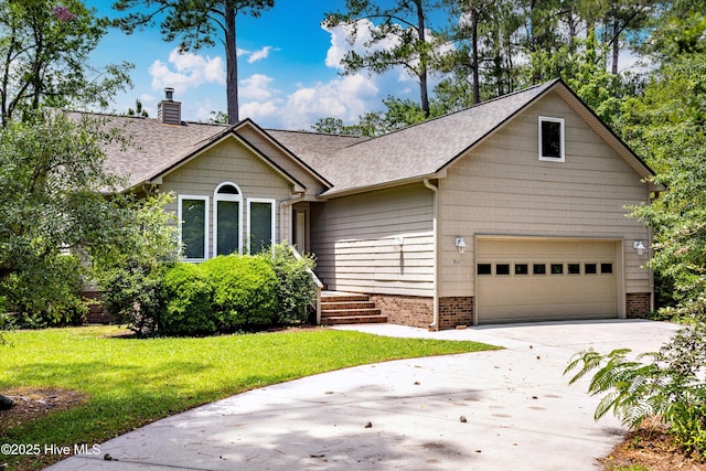 7015 Fairwinds Dr, Oriental, NC 28571 - view of front of home featuring roof with shingles, a chimney, a garage, a front yard, and driveway