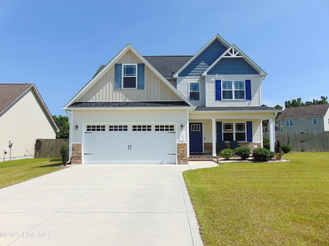 205 Brice Ct, Hubert, NC 28539 - craftsman-style house featuring board and batten siding, driveway, stone siding, and covered porch
