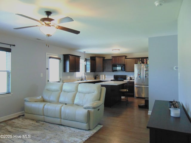205 Brice Ct, Hubert, NC 28539 - living room featuring healthy amount of natural light, dark wood-style flooring, baseboards, and a ceiling fan