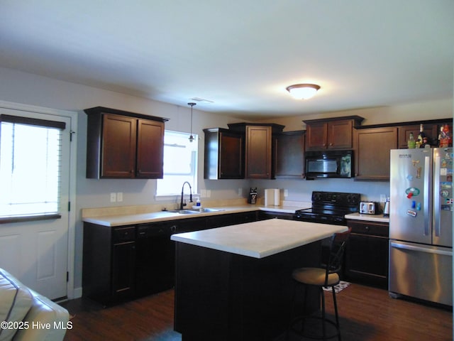 205 Brice Ct, Hubert, NC 28539 - kitchen with black appliances, light countertops, a sink, dark wood-type flooring, and a kitchen island