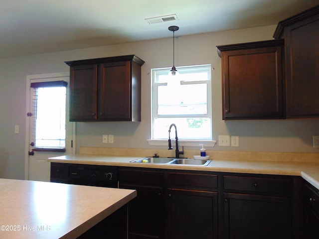 205 Brice Ct, Hubert, NC 28539 - kitchen with a sink, dark brown cabinets, light countertops, and pendant lighting