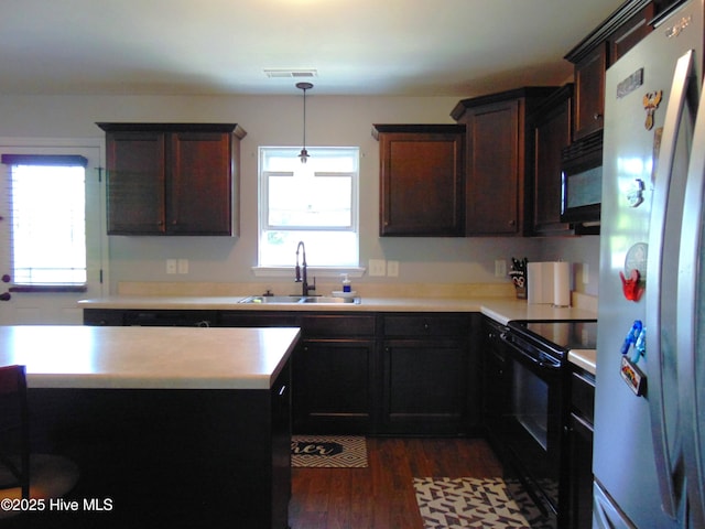 205 Brice Ct, Hubert, NC 28539 - kitchen with black appliances, a sink, light countertops, and dark wood-style flooring