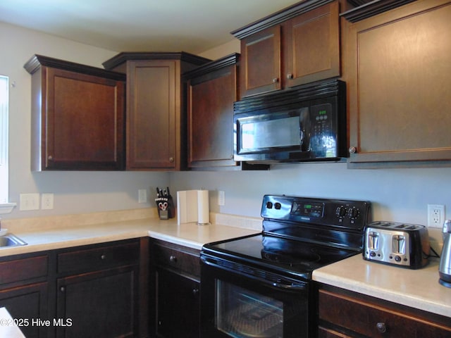 205 Brice Ct, Hubert, NC 28539 - kitchen featuring black appliances, light countertops, and dark brown cabinets