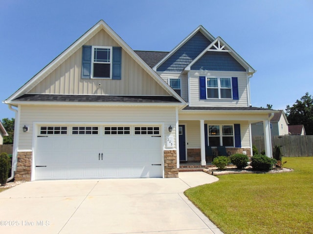205 Brice Ct, Hubert, NC 28539 - craftsman-style home featuring covered porch, stone siding, concrete driveway, and board and batten siding