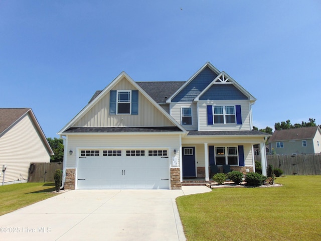 205 Brice Ct, Hubert, NC 28539 - craftsman house with driveway, covered porch, stone siding, board and batten siding, and a garage