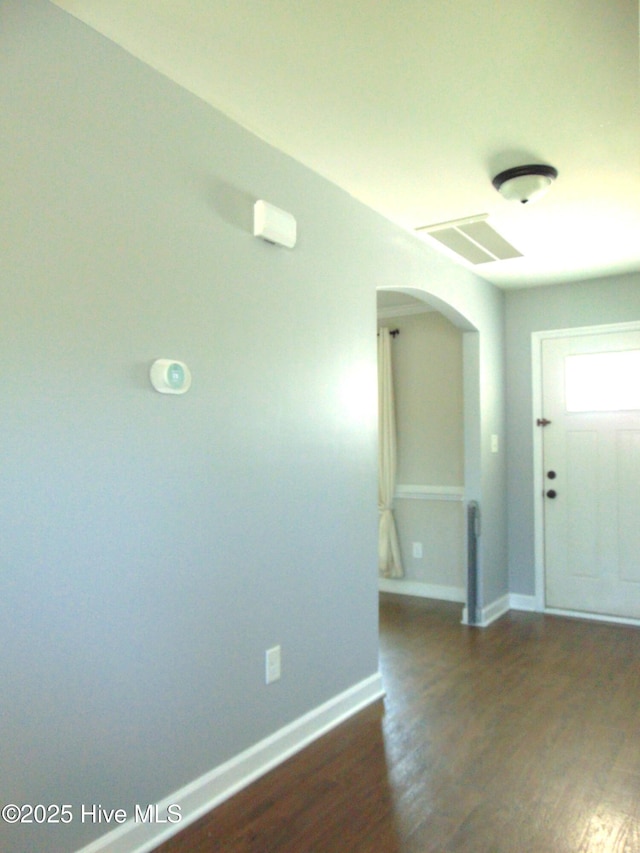 205 Brice Ct, Hubert, NC 28539 - entrance foyer featuring arched walkways, dark wood-style flooring, and baseboards