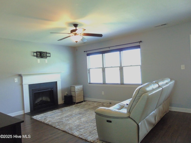 205 Brice Ct, Hubert, NC 28539 - living room featuring a ceiling fan, dark wood-style floors, baseboards, and a fireplace