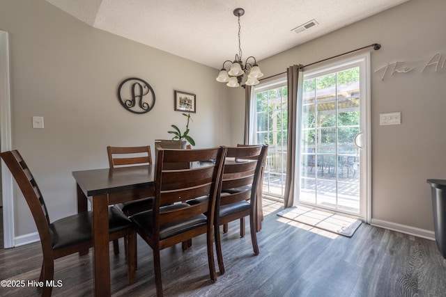 306 Top Knot Rd, Hubert, NC 28539 - dining space featuring wood finished floors, a chandelier, and baseboards