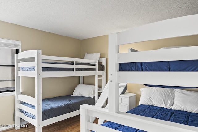 1505 Salter Path Rd Unit 328, Indian Beach, NC 28512 - bedroom featuring wood finished floors and a textured ceiling