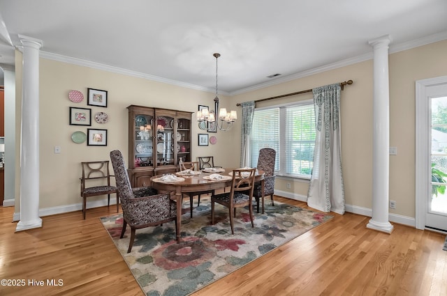 4301 Gainesford Ct, Wilmington, NC 28412 - dining area featuring decorative columns, light wood-style flooring, healthy amount of natural light, ornamental molding, and a chandelier