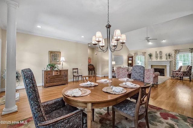 4301 Gainesford Ct, Wilmington, NC 28412 - dining room featuring ceiling fan, wood finished floors, a fireplace, decorative columns, and a chandelier