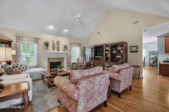 4301 Gainesford Ct, Wilmington, NC 28412 - living area featuring ceiling fan, a glass covered fireplace, high vaulted ceiling, and light wood-style floors
