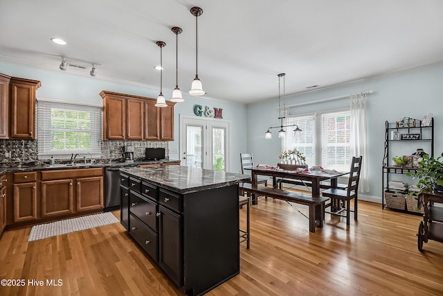 4301 Gainesford Ct, Wilmington, NC 28412 - kitchen with stainless steel dishwasher, light wood finished floors, a kitchen island, backsplash, and crown molding