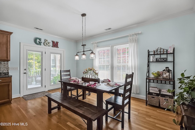 4301 Gainesford Ct, Wilmington, NC 28412 - dining room with light wood finished floors and ornamental molding