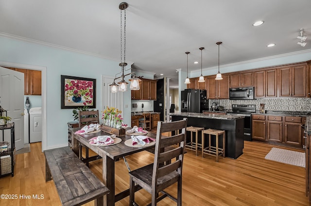 4301 Gainesford Ct, Wilmington, NC 28412 - dining space featuring crown molding, washer / dryer, light wood-style flooring, and recessed lighting
