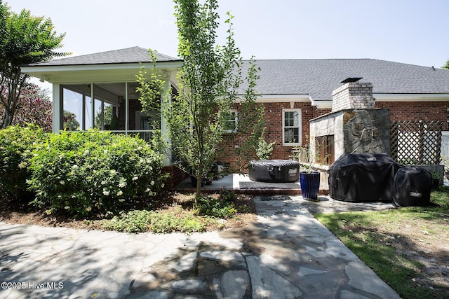 4301 Gainesford Ct, Wilmington, NC 28412 - rear view of house featuring brick siding, a patio area, roof with shingles, and a sunroom